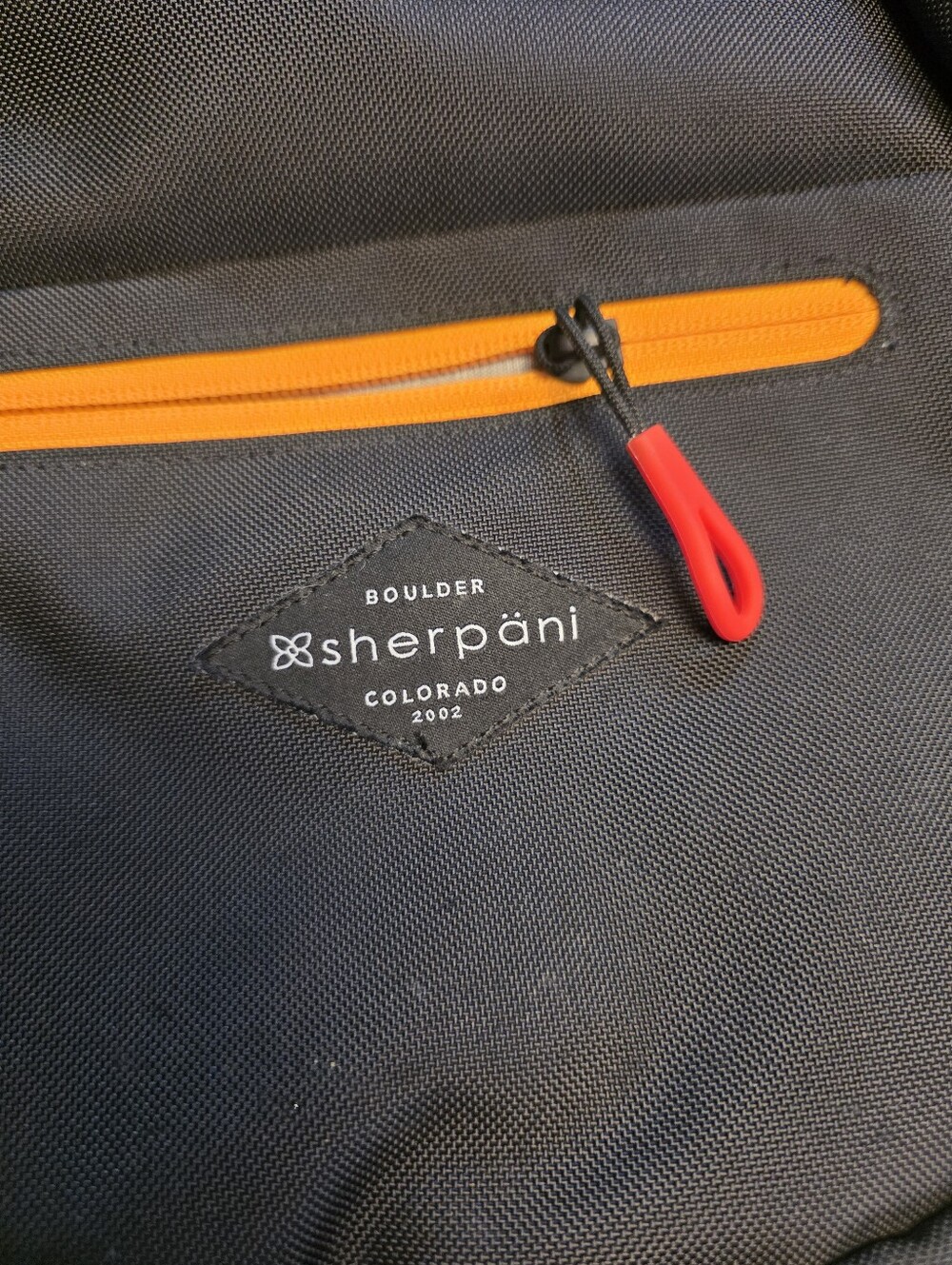 Sherpani black sling bag with blue and orange accents - Picture 4 of 5